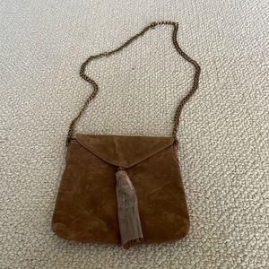 Faux suede crossbody bag.  Cloth Lined & Zipper closure.  Brass chain. NWOT.